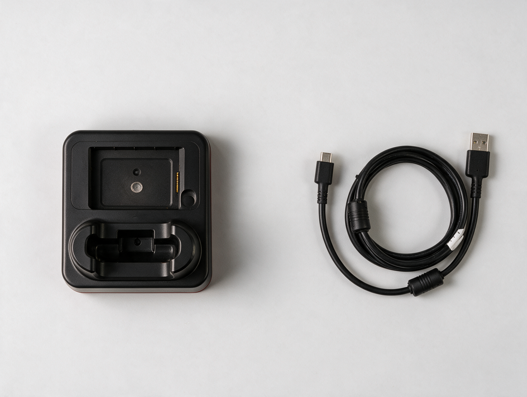 EDA52-HB-2 charging station and ScanPal EDA52 USB-C cable side by side